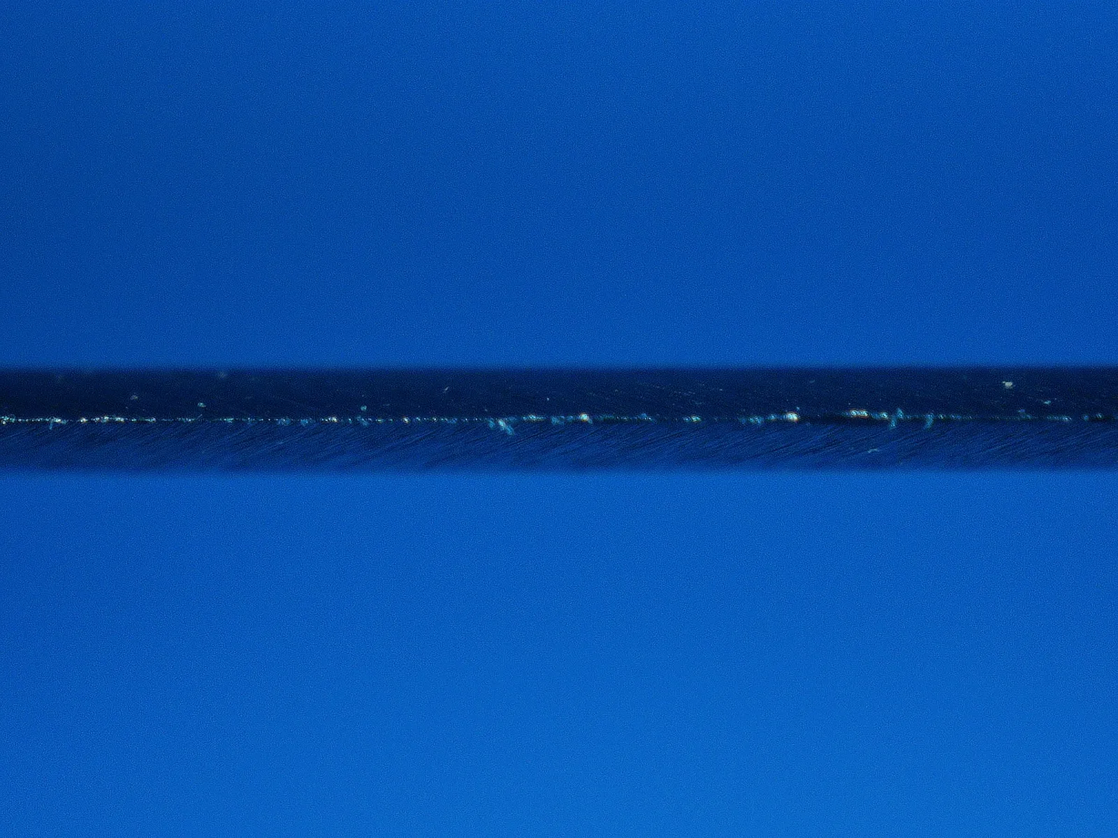 Dull knife edge showing reflected light and edge damage
